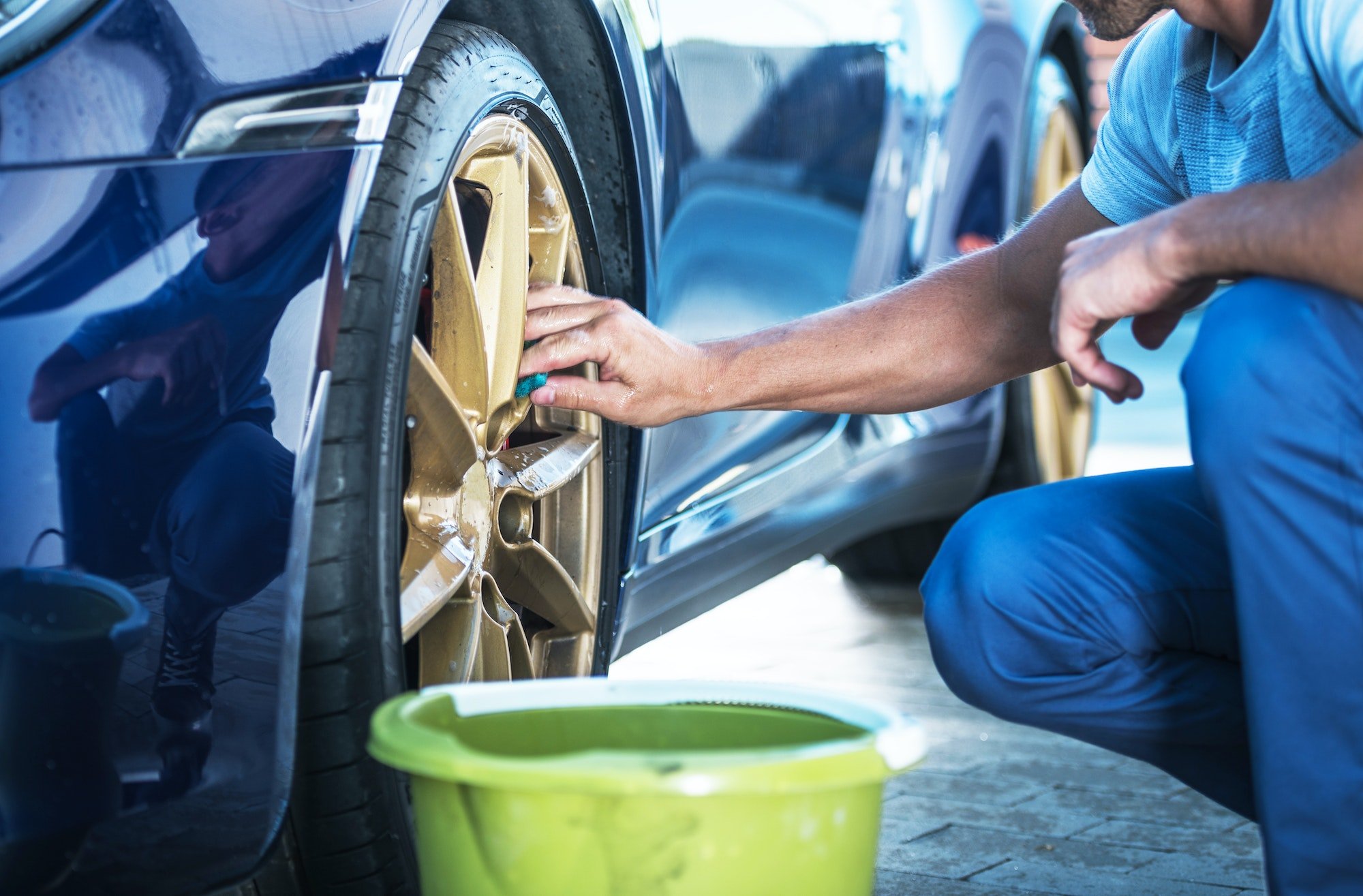 Men Detailing His Exotic Car Alloy Wheels