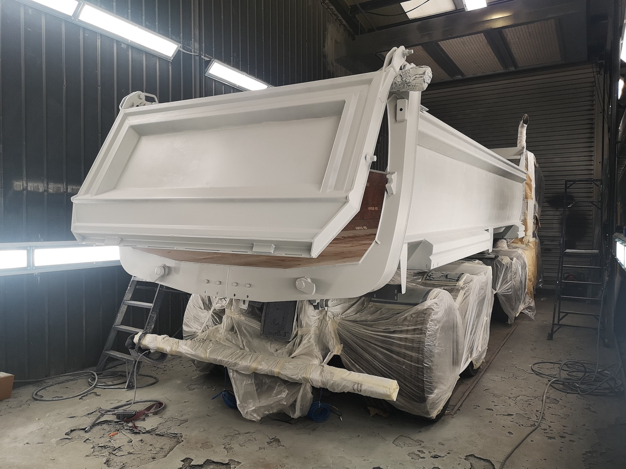 Truck painted white standing in a warehouse